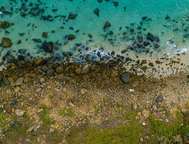 抽象的空中照片卵石海滩旁边的蓝色大海与海浪，Con岛，Con Son岛，巴里亚头省